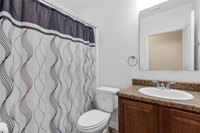 bathroom featuring vanity, toilet, and a shower with shower curtain