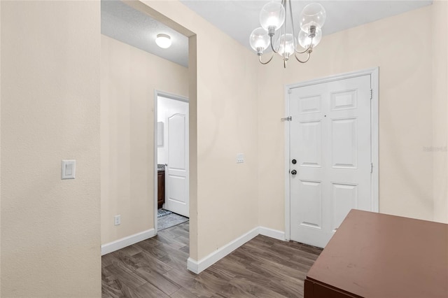 entryway featuring a notable chandelier and hardwood / wood-style flooring