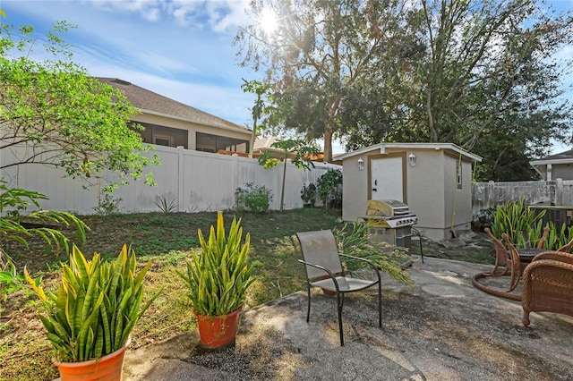 view of patio featuring a shed and grilling area