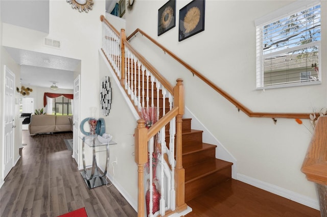 staircase with hardwood / wood-style floors