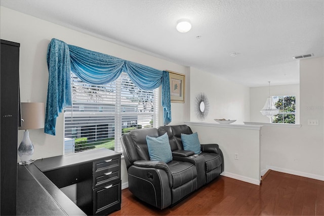 sitting room featuring a textured ceiling and dark hardwood / wood-style flooring