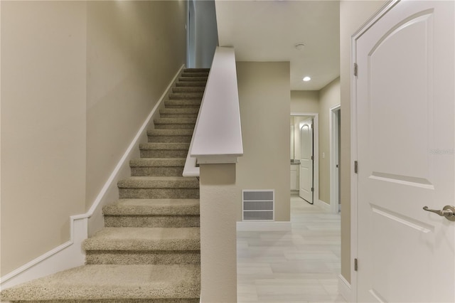 stairs with hardwood / wood-style floors