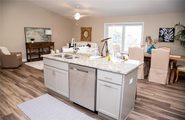 kitchen with hardwood / wood-style flooring, sink, stainless steel dishwasher, white cabinets, and ceiling fan