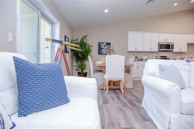 bedroom with vaulted ceiling and light wood-type flooring