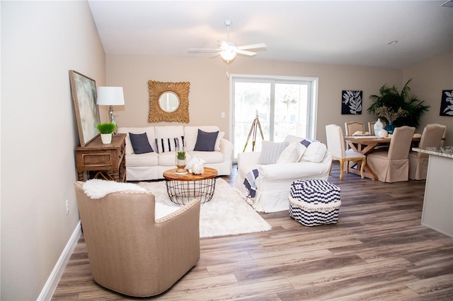 living room with ceiling fan and hardwood / wood-style floors