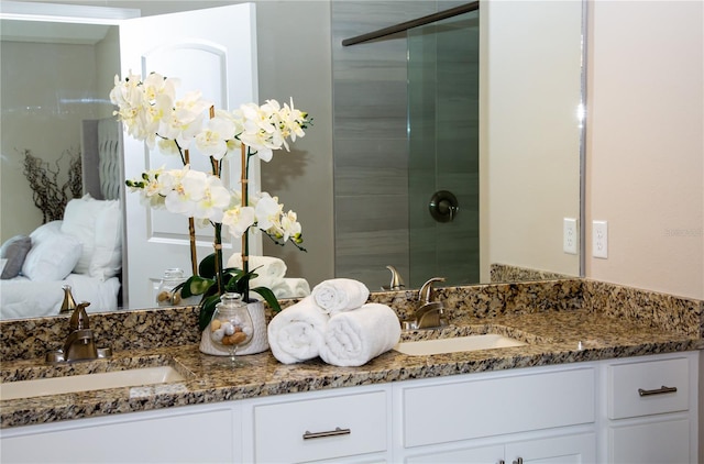 bathroom featuring vanity and a shower with shower door