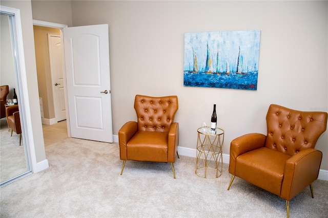 sitting room featuring light carpet