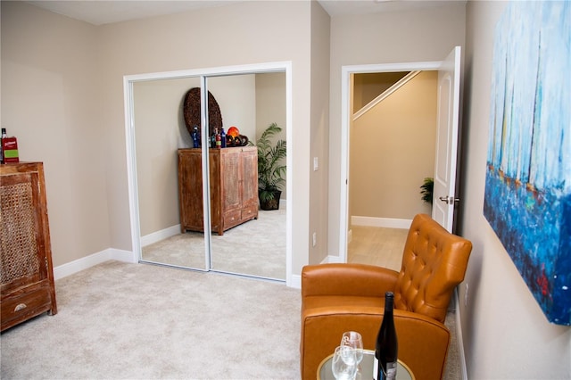 sitting room featuring light colored carpet