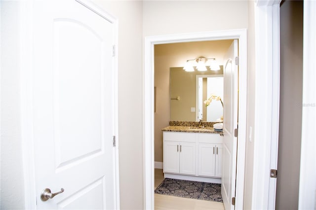 bathroom with vanity and hardwood / wood-style flooring