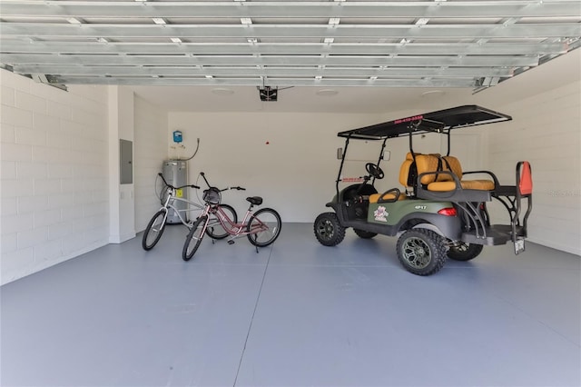 garage featuring a garage door opener, electric water heater, and electric panel