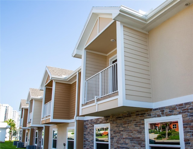 view of home's exterior featuring central AC unit and a balcony