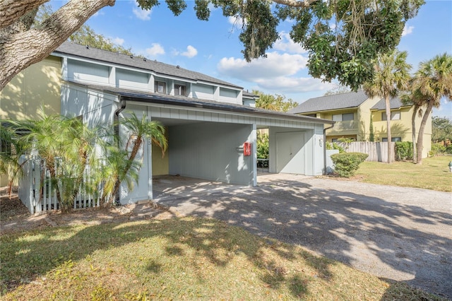 view of front of home with a carport and a front yard