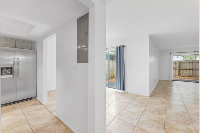 corridor with electric panel and light tile patterned floors