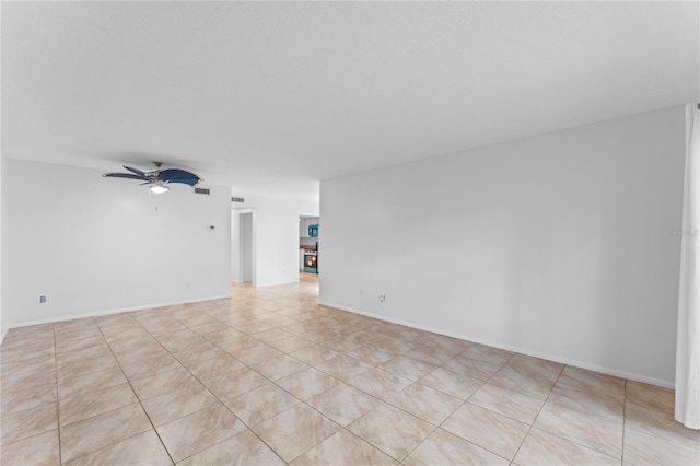 spare room featuring ceiling fan and light tile patterned floors