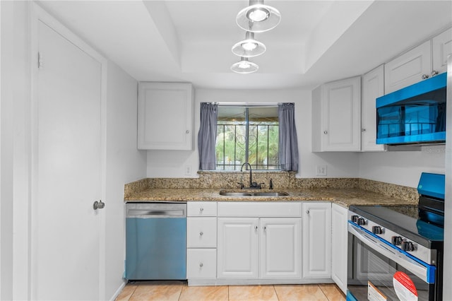 kitchen with white cabinetry, stainless steel appliances, sink, and a tray ceiling