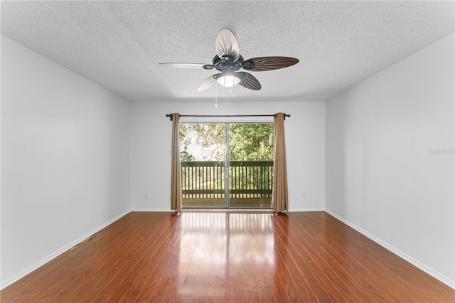 empty room with hardwood / wood-style floors, ceiling fan, and a textured ceiling