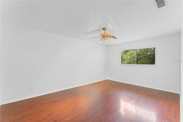 unfurnished room with hardwood / wood-style floors, a textured ceiling, and ceiling fan