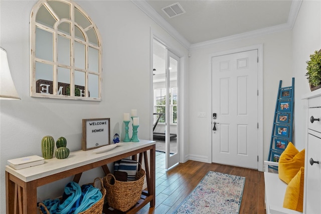 entrance foyer with ornamental molding and dark hardwood / wood-style floors