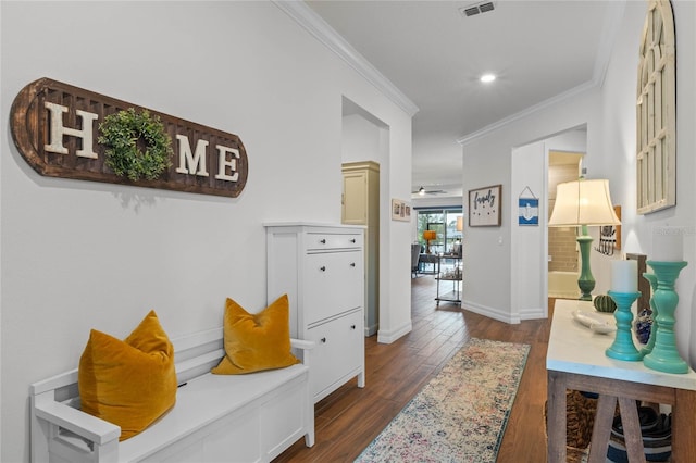 interior space with ornamental molding and dark hardwood / wood-style floors