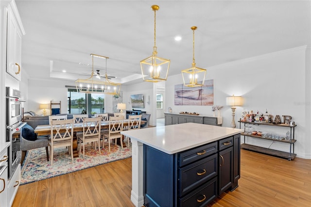 kitchen with a chandelier, white cabinets, decorative light fixtures, and light hardwood / wood-style floors