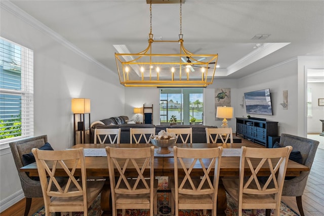 dining area featuring a notable chandelier, ornamental molding, hardwood / wood-style flooring, and plenty of natural light