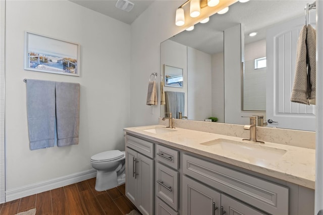 bathroom with vanity, hardwood / wood-style floors, and toilet