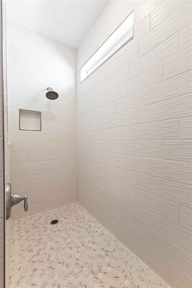 bathroom with a tile shower