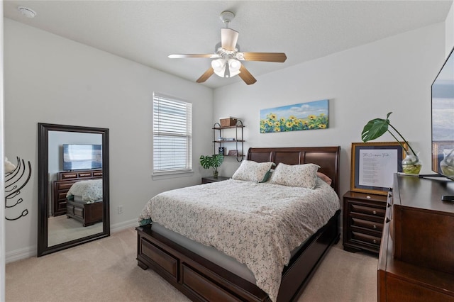 bedroom featuring light carpet and ceiling fan