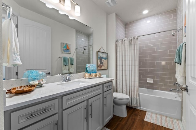 full bathroom featuring toilet, shower / bath combo with shower curtain, vanity, and wood-type flooring