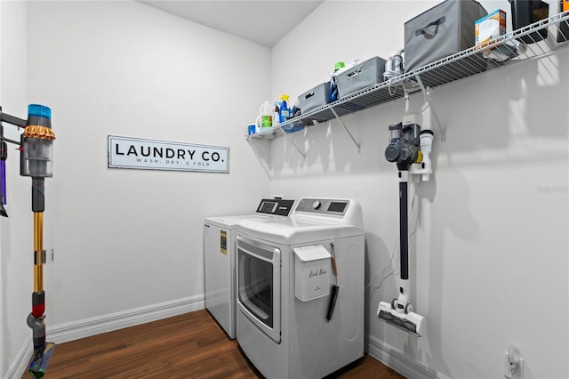 laundry room with independent washer and dryer and dark wood-type flooring