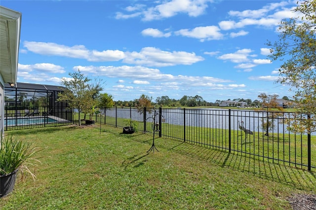 view of yard with a fenced in pool, a lanai, and a water view