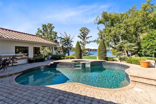 view of pool with an in ground hot tub, a patio, and a water view