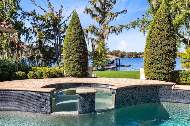 view of swimming pool featuring an in ground hot tub and a water view