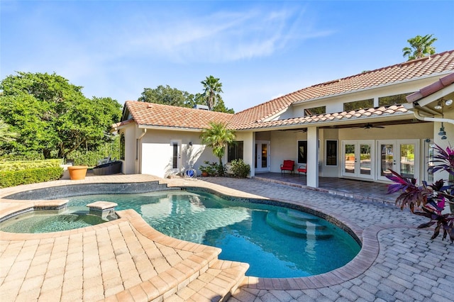 view of pool with ceiling fan, a patio area, an in ground hot tub, and french doors