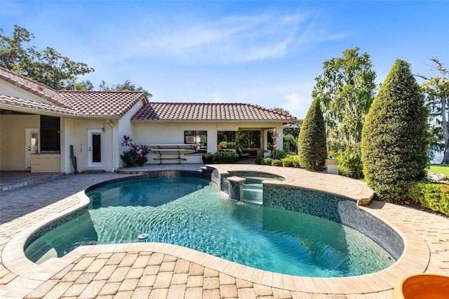 view of swimming pool featuring an in ground hot tub and a patio