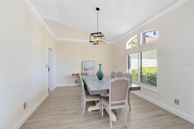 dining space with a notable chandelier, light hardwood / wood-style floors, and ornamental molding