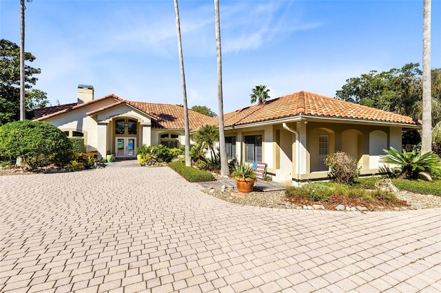 mediterranean / spanish house featuring french doors