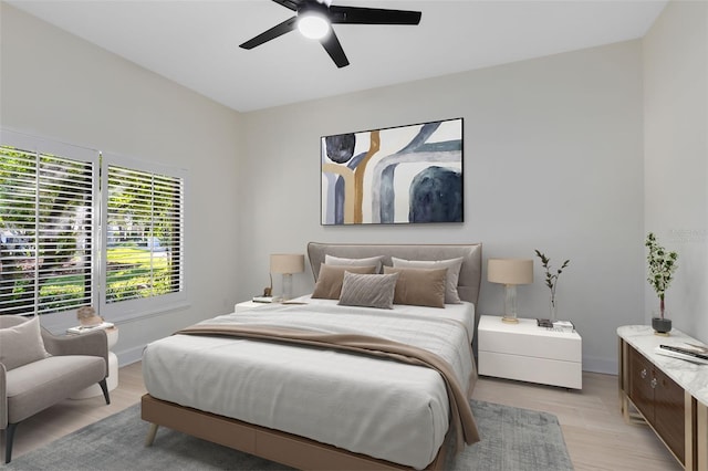 bedroom with light hardwood / wood-style floors and ceiling fan