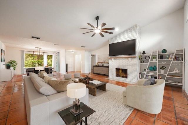 living room featuring a fireplace, ceiling fan with notable chandelier, lofted ceiling, and tile patterned floors