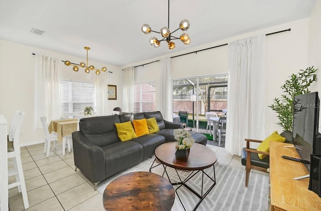 tiled living room featuring a chandelier