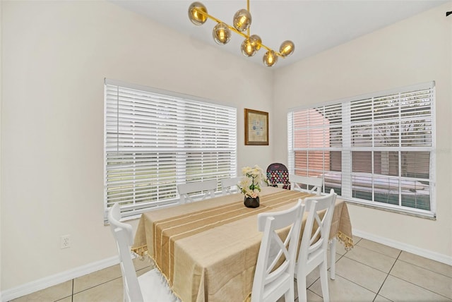 tiled dining area with a wealth of natural light and a chandelier