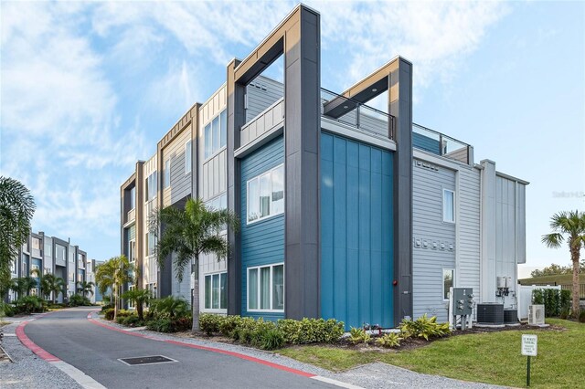 view of building exterior with central AC unit