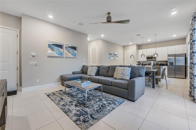 living room featuring ceiling fan and light tile patterned flooring