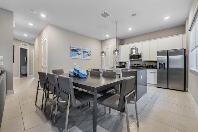 tiled dining area featuring sink