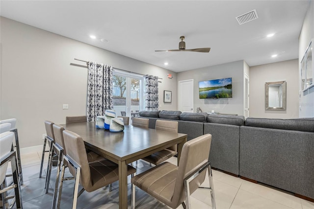 tiled dining space featuring ceiling fan