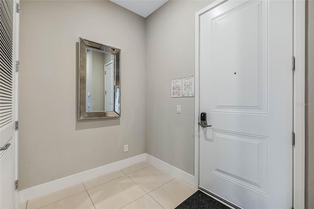 doorway to outside with light tile patterned flooring