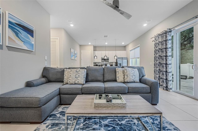 tiled living room featuring ceiling fan