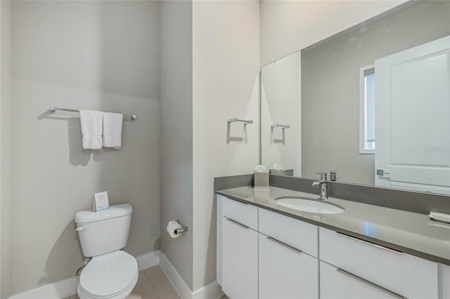 bathroom featuring toilet, vanity, and tile patterned floors