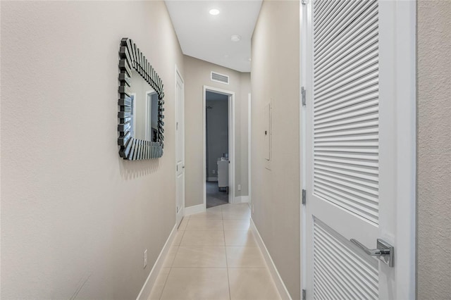 corridor featuring light tile patterned flooring