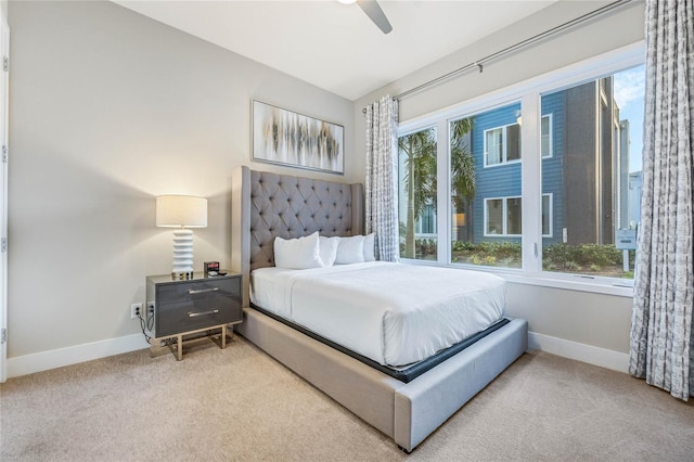 carpeted bedroom with multiple windows and ceiling fan